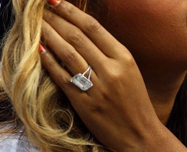 Blonde woman wearing an emerald cut engagement ring